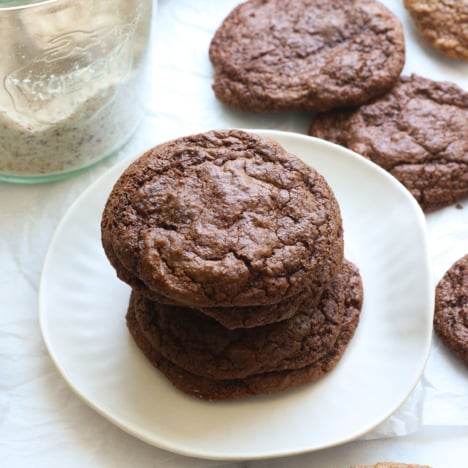 almond meal cookies stacked on a white plate.