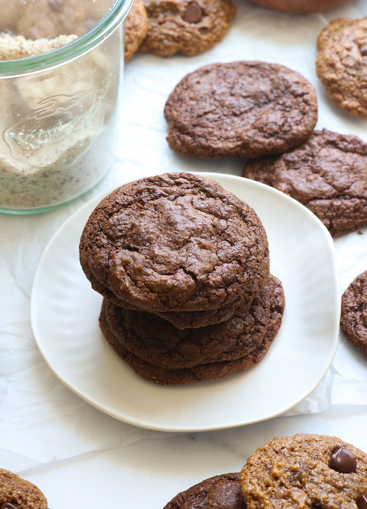 Almond cookies stacked on a white plate.