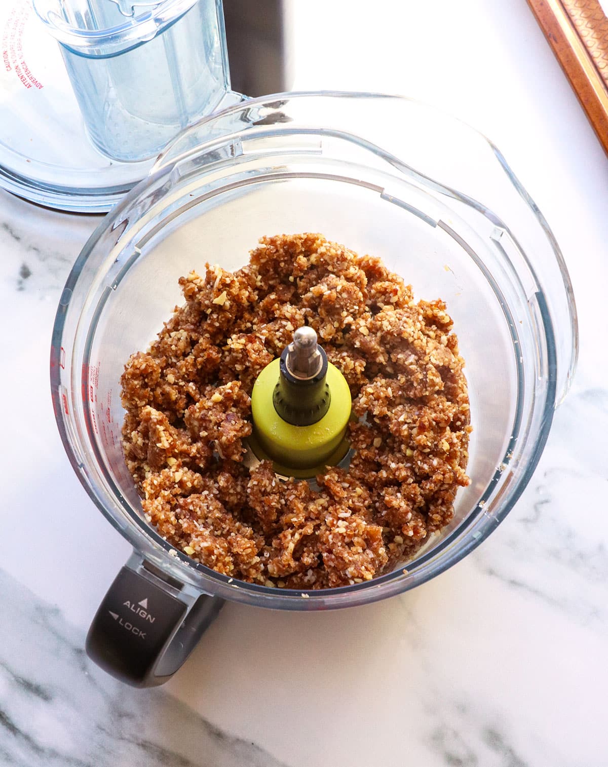 Date walnut mixture in a food processor after pulverizing it.
