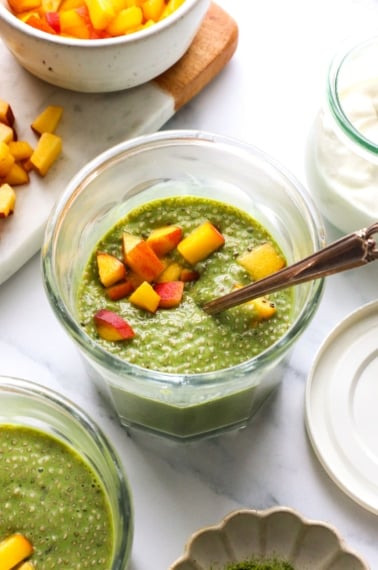 matcha chia pudding topped with peaches.
