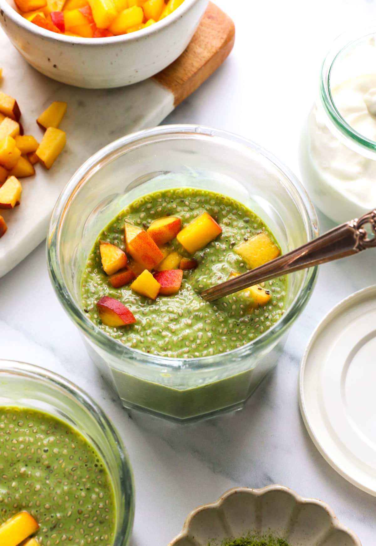 matcha chia pudding topped with peaches.