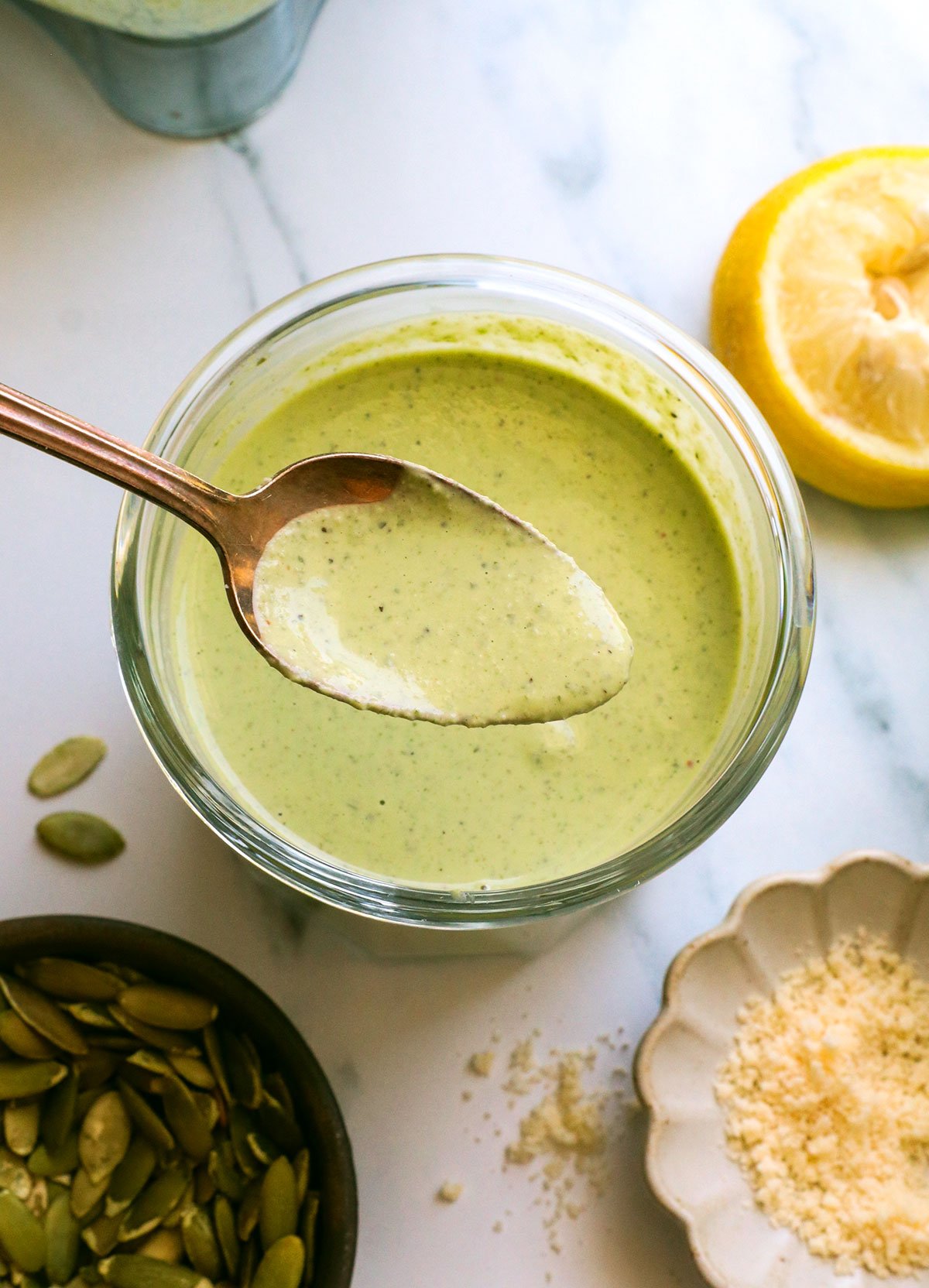 pumpkin seed pesto in a jar and lifted on a spoon. 
