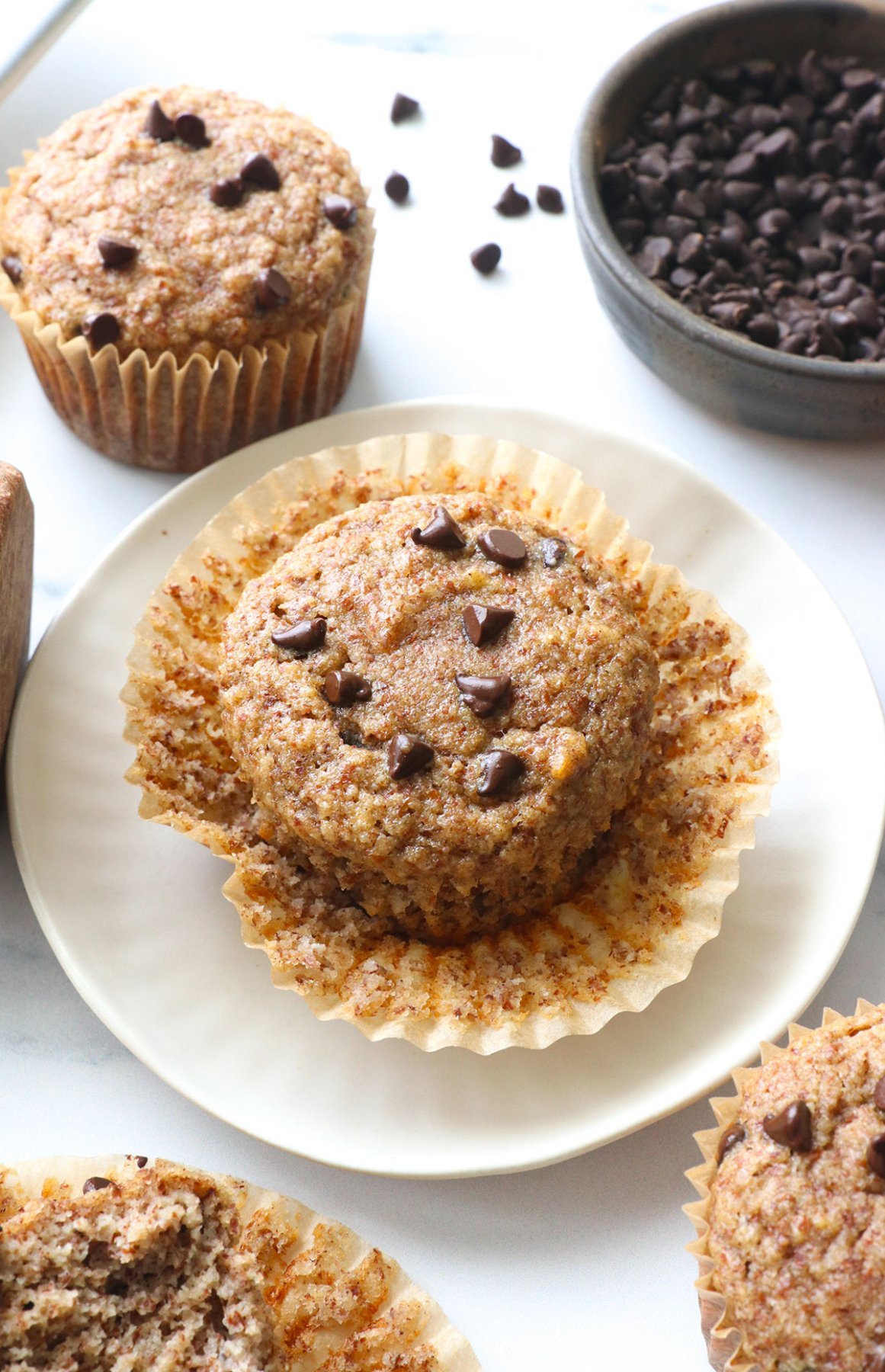 almond meal muffin on a plate unwrapped. 