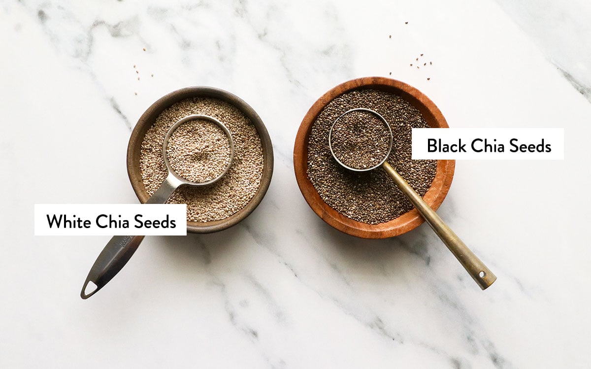 white vs black chia seeds labeled in bowls.