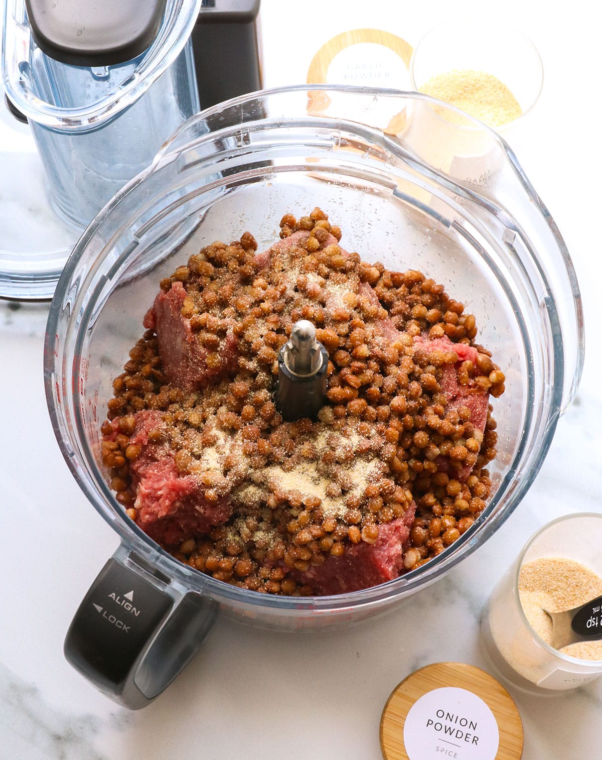 ground beef and lentils added to a food processor.