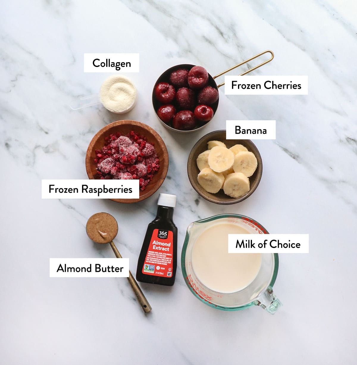 frozen cherries, raspberries, banana, milk, collagen and almond butter labeled.