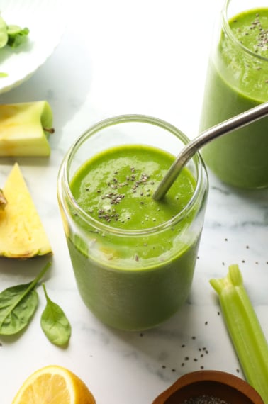detox smoothie with chia seeds and a stainless steel straw.