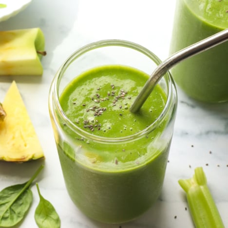 detox smoothie with chia seeds and a stainless steel straw.