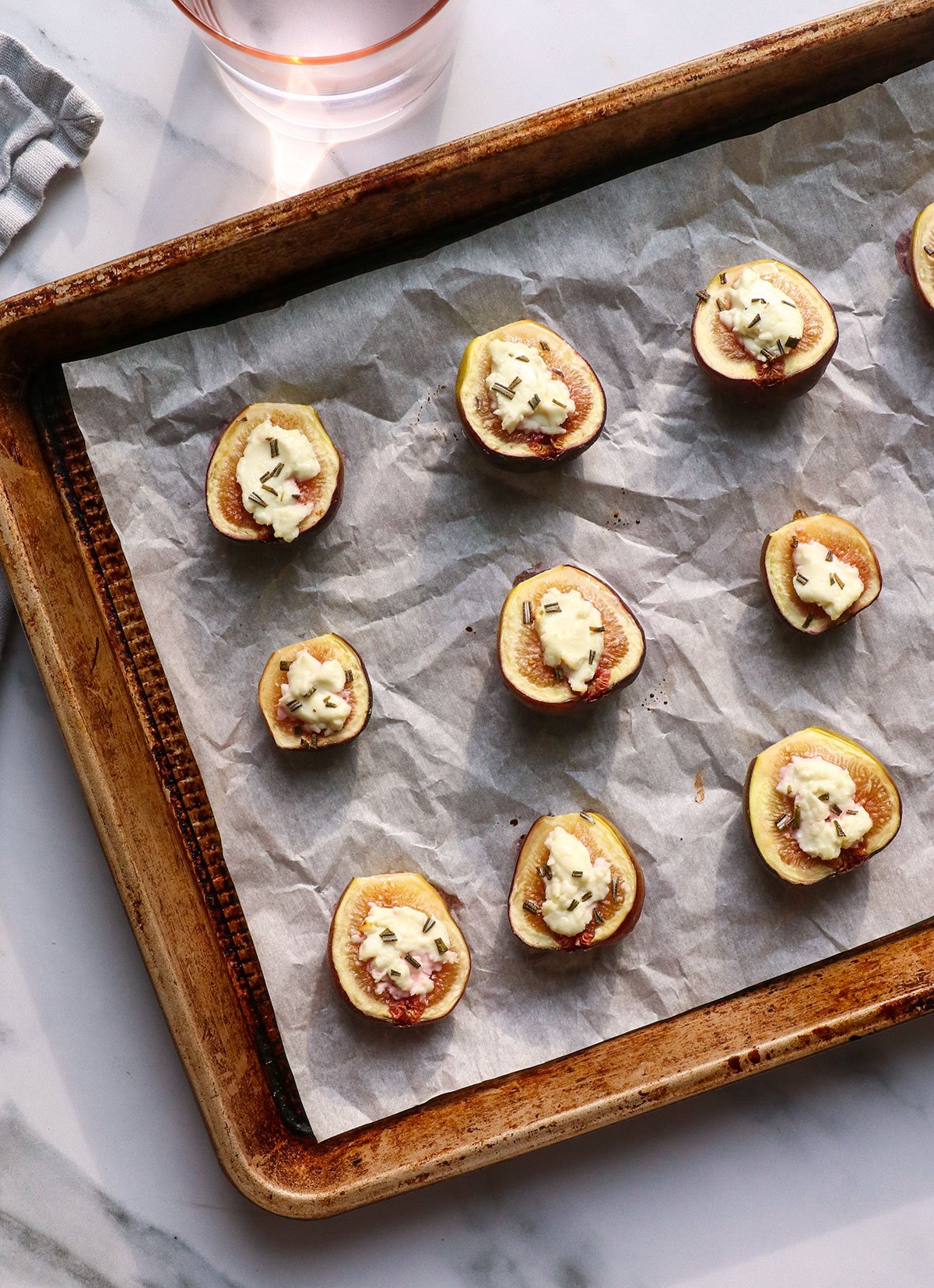 figs on a pan after baking with goat cheese and rosemary.