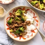 ground beef and broccoli served in a colorful bowl with white rice.