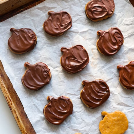 chocolate covered peanut butter pumpkins on a baking sheet.