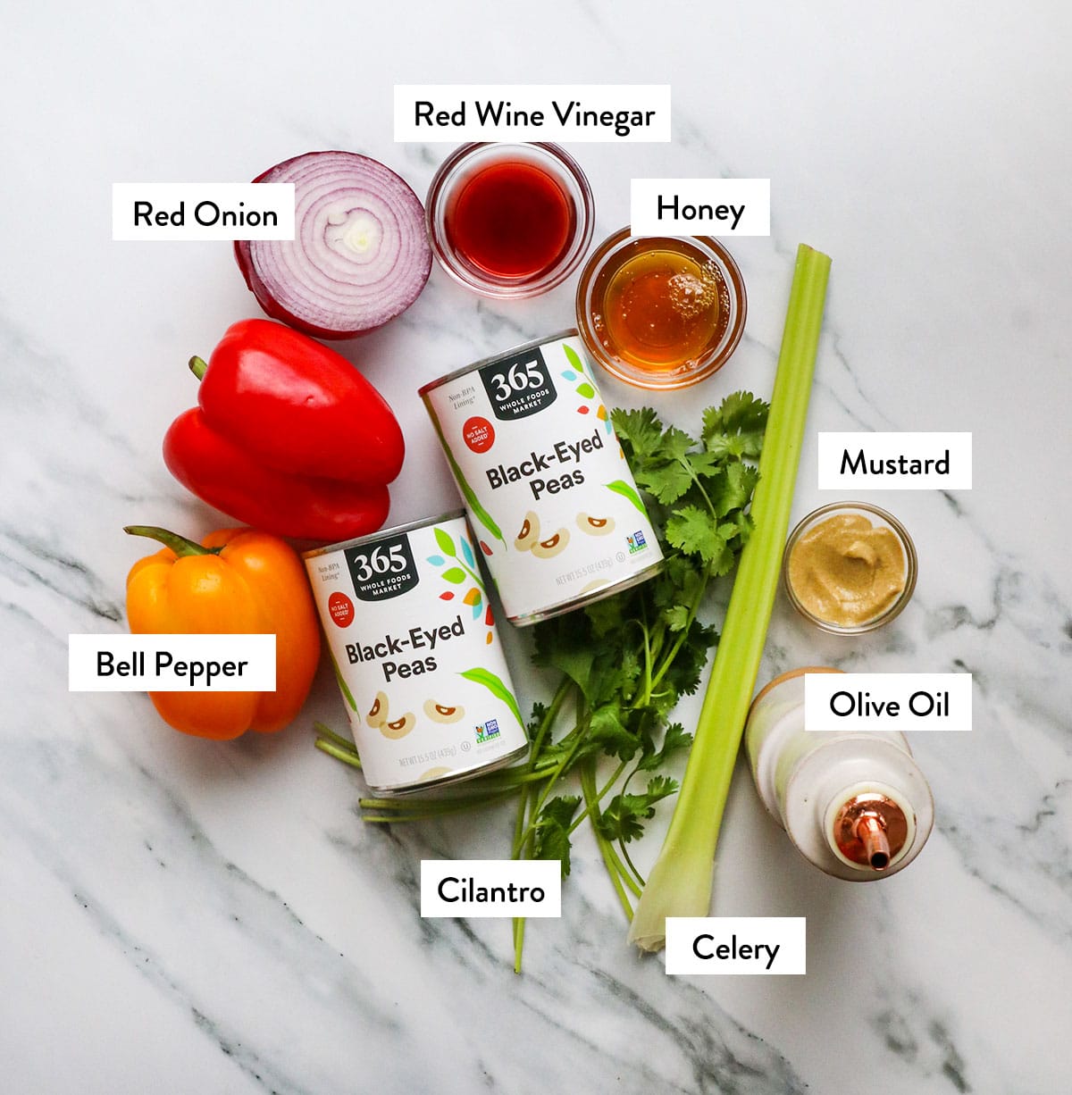 black eyed peas, peppers, onion, celery, and cilantro labeled on a white surface.