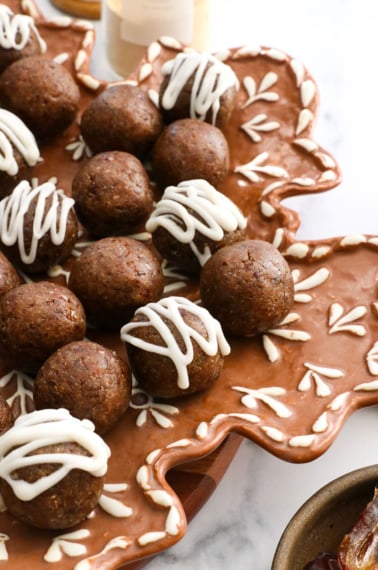 gingerbread energy balls served on a gingerbread snowflake plate.