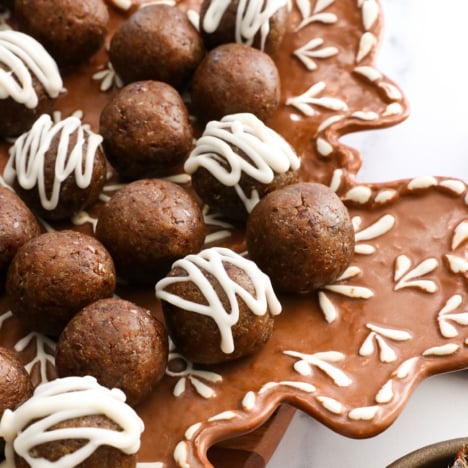 gingerbread energy balls served on a gingerbread snowflake plate.