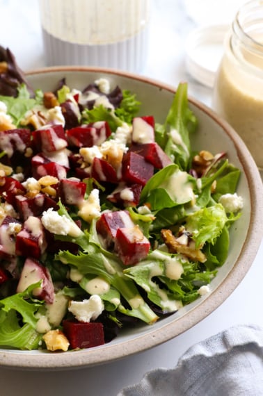 Shallot vinaigrette drizzled over a salad with beets and goat cheese.
