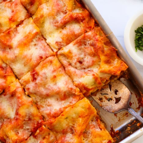 cottage cheese lasagna sliced in a pan into 12 squares.