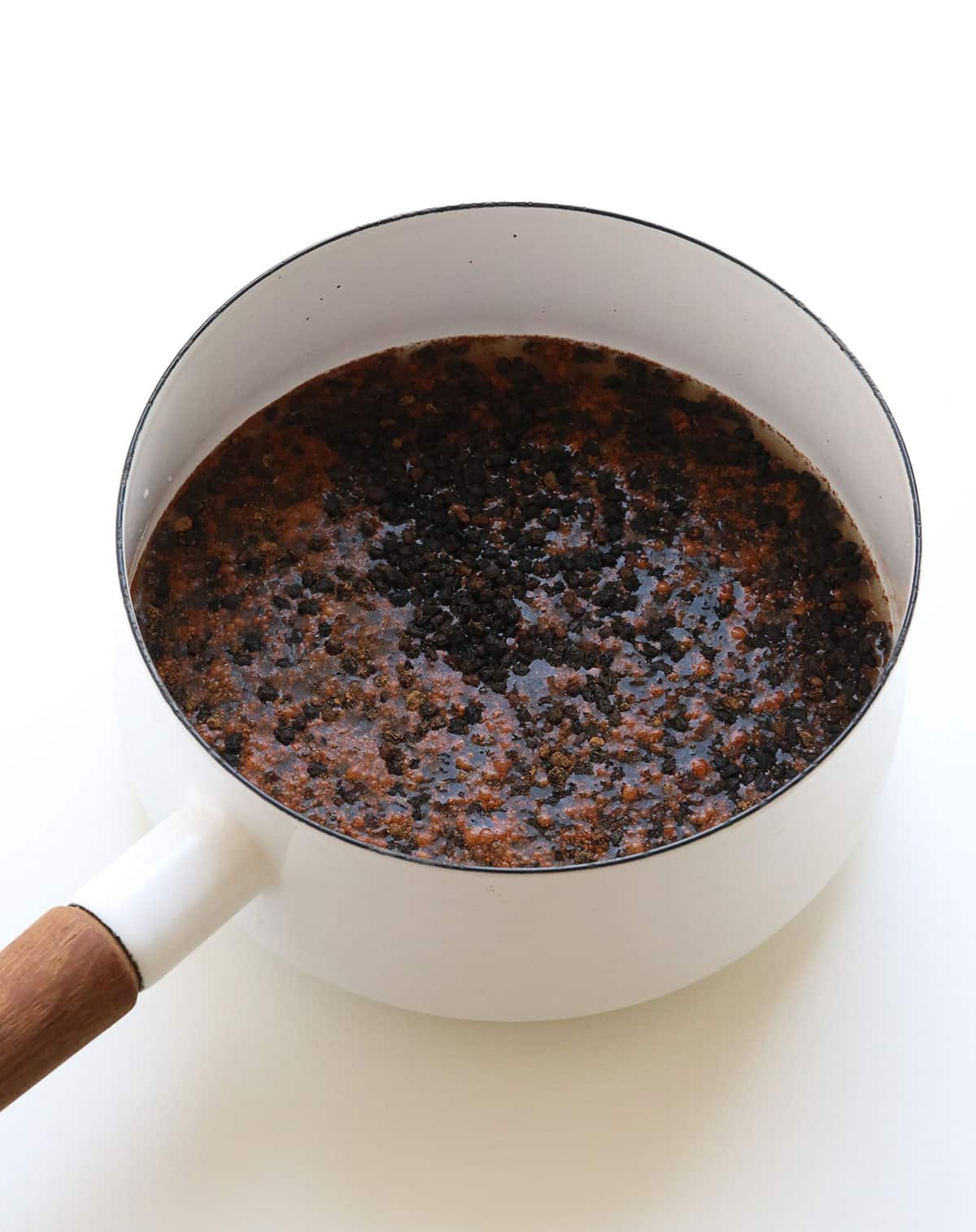 water added to the pot of elderberries and spices.