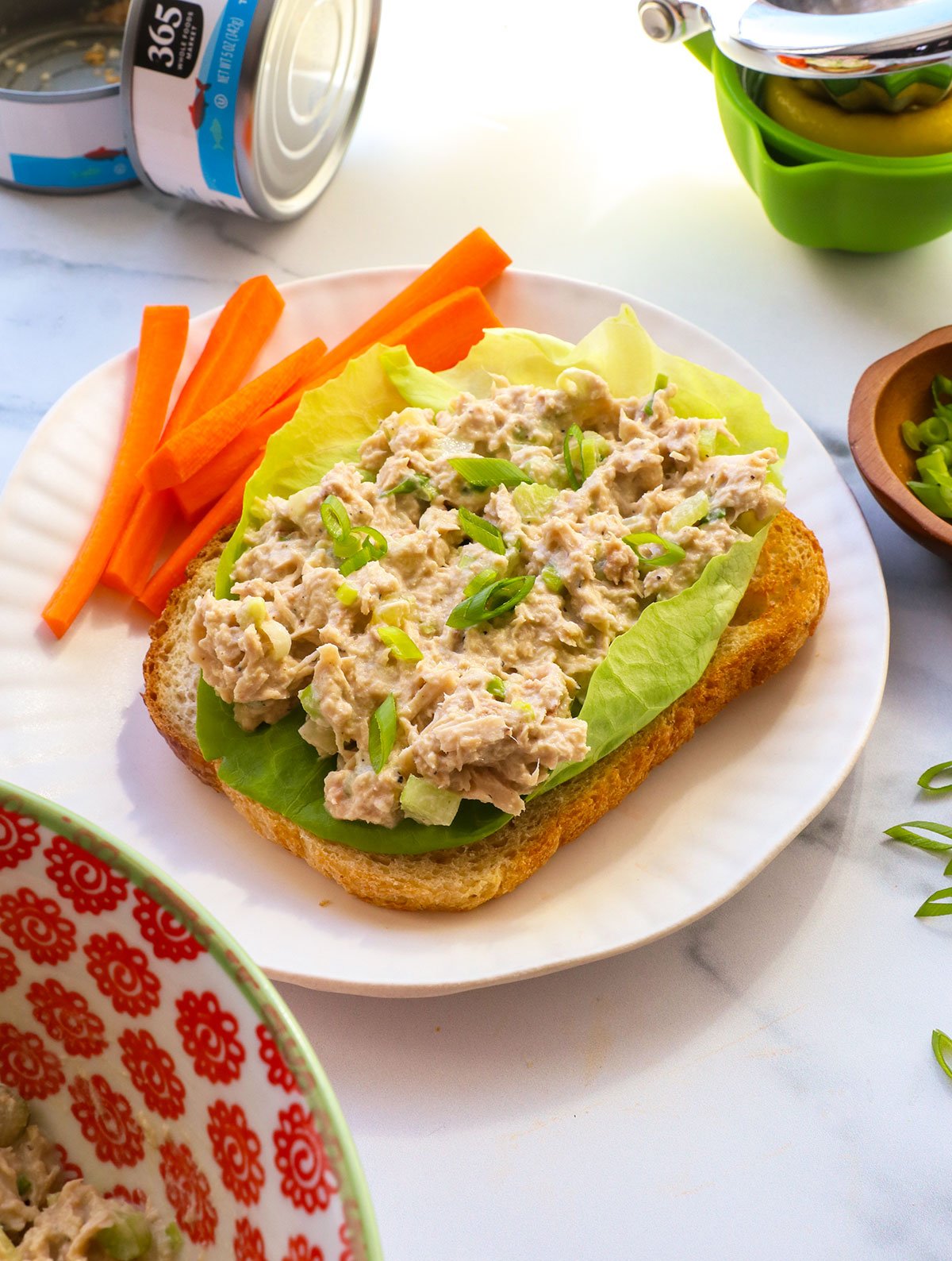 healthy tuna salad served on butter lettuce with toast.