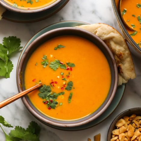 pumpkin curry soup served with cilantro on top.