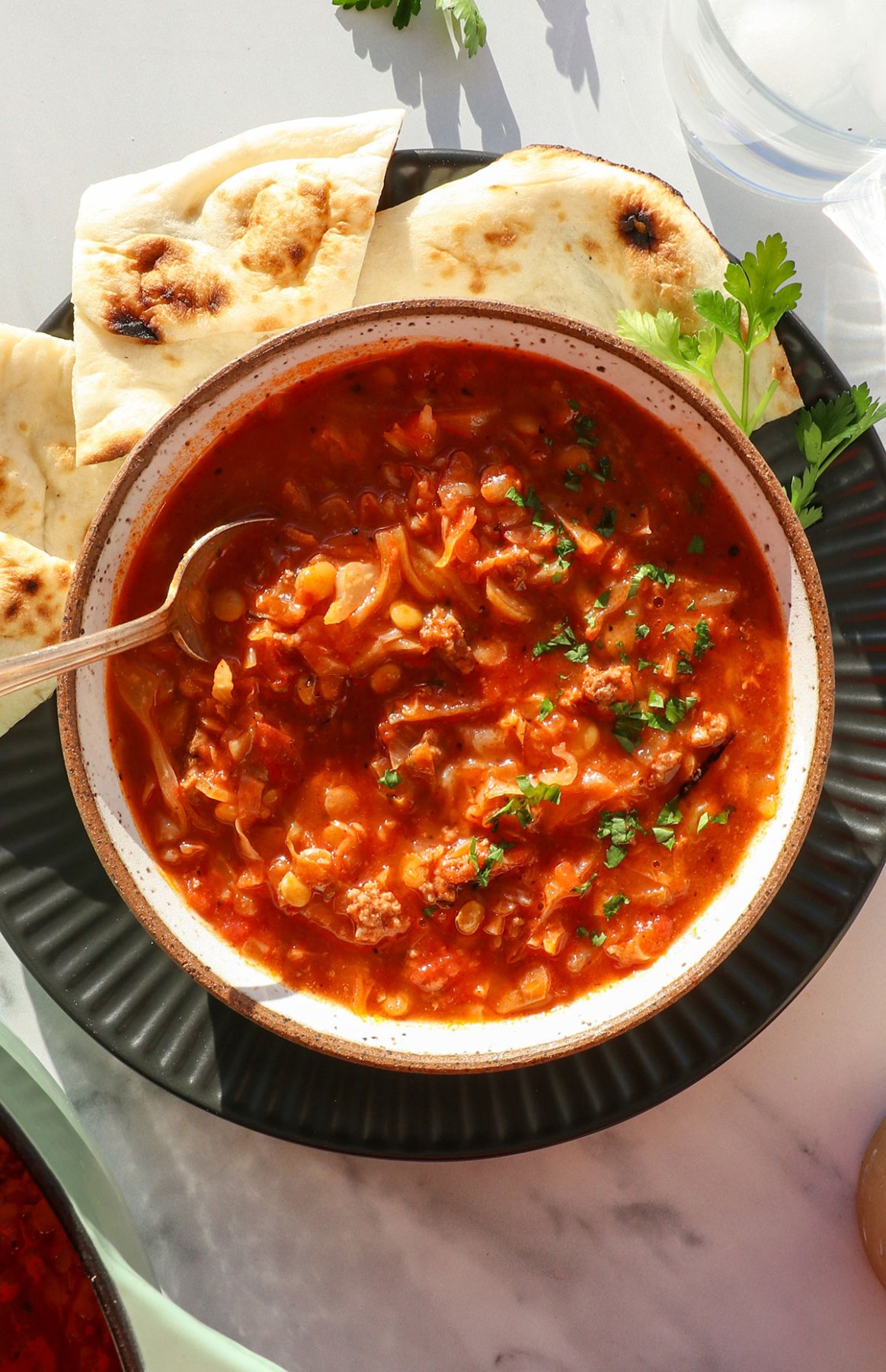 stuffed cabbage soup served in a bowl with lentils.