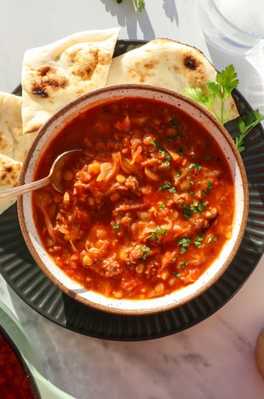 stuffed cabbage soup served in a bowl with lentils.
