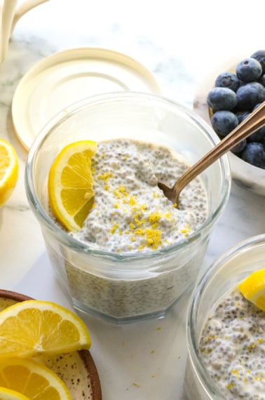 lemon chia pudding topped with a lemon slice and zest.