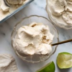 coconut milk ice cream in bowls with limes nearby.