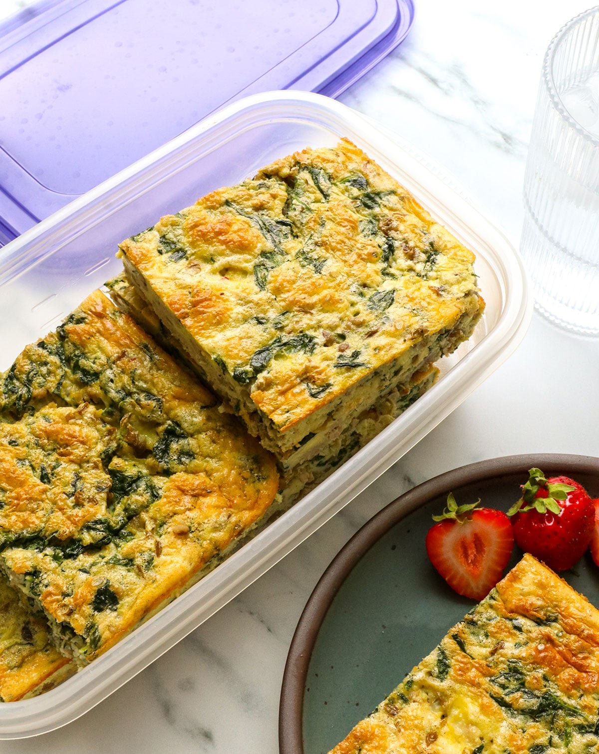 cottage cheese egg bake slices stored in a container with a lid. 