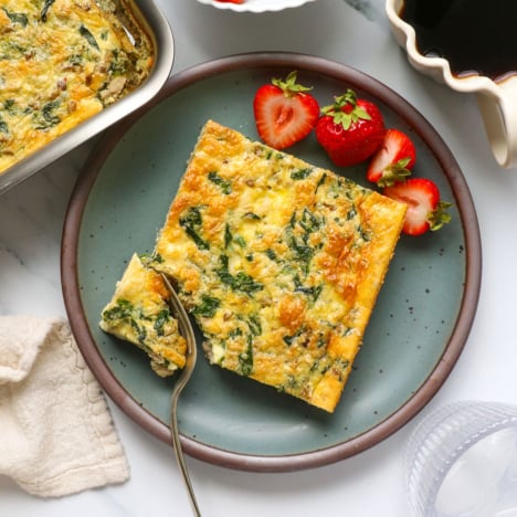 cottage cheese egg casserole served with berries on a plate.