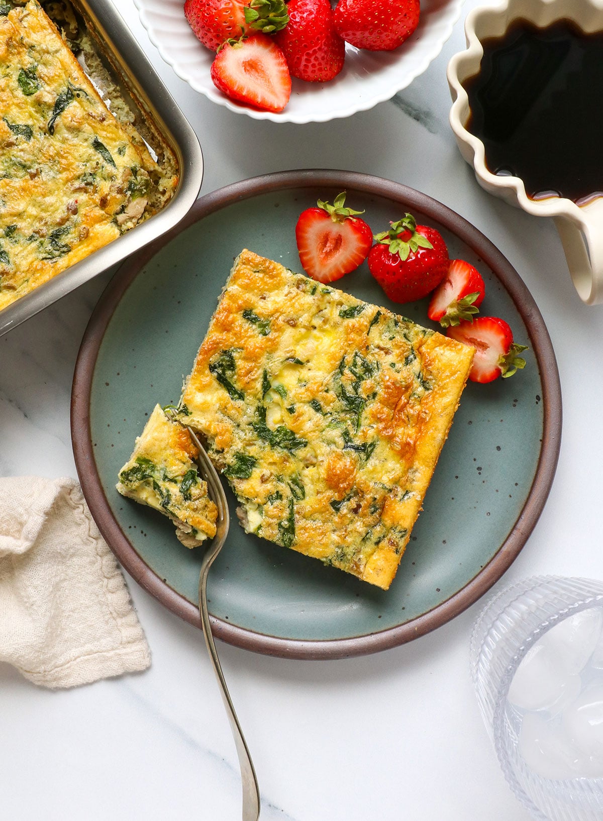 cottage cheese egg casserole served with berries on a plate.
