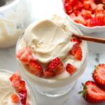 greek yogurt ice cream served in a glass dish with strawberries.