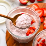 strawberry chia pudding lifted on a spoon to show the texture.