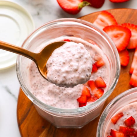 strawberry chia pudding lifted on a spoon to show the texture.