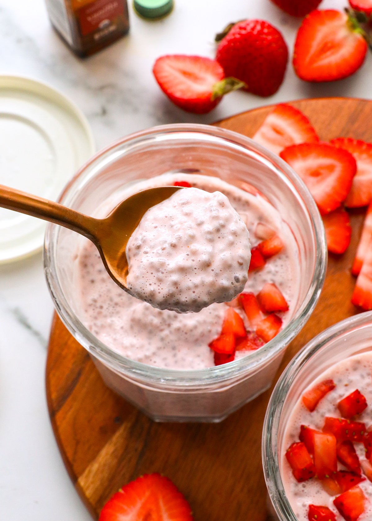 strawberry chia pudding lifted on a spoon to show the texture.