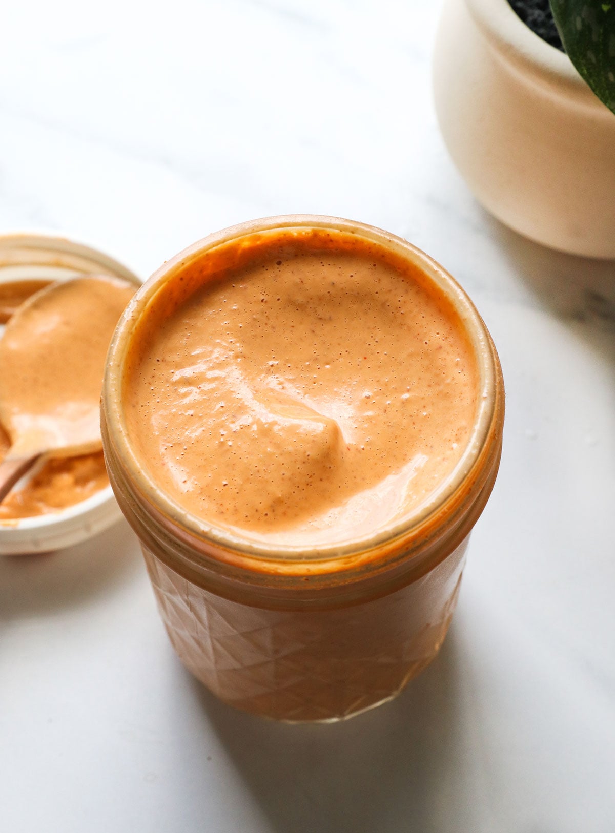 healthy chipotle sauce in a glass jar with a lid.