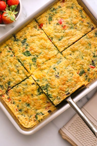 vegetarian egg casserole sliced for serving in a pan.