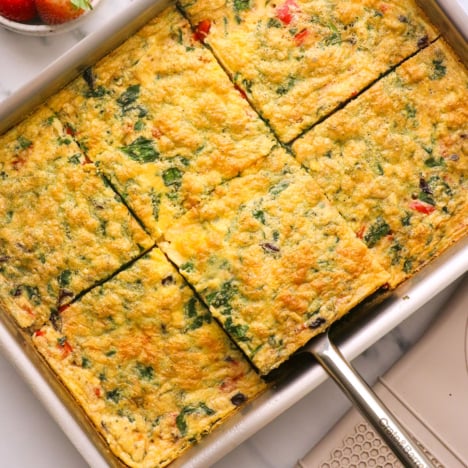 vegetarian egg casserole sliced for serving in a pan.
