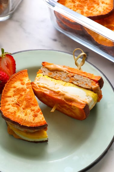 healthy breakfast sandwich sliced in half on a blue plate.