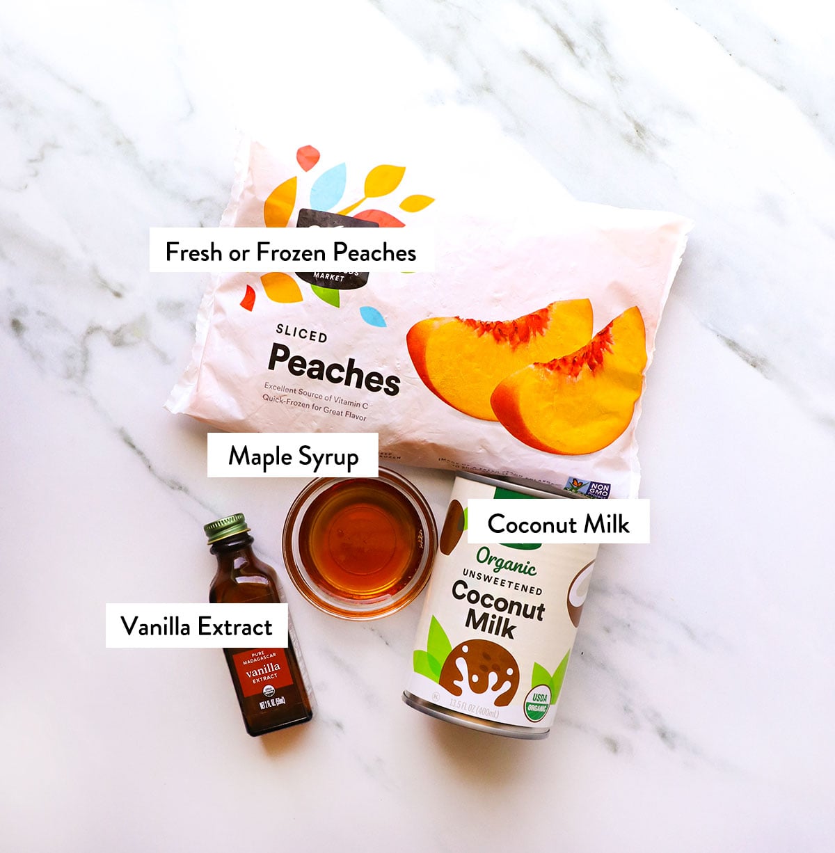 bag of peaches, coconut milk, maple syrup, and vanilla extract labeled on a white surface.