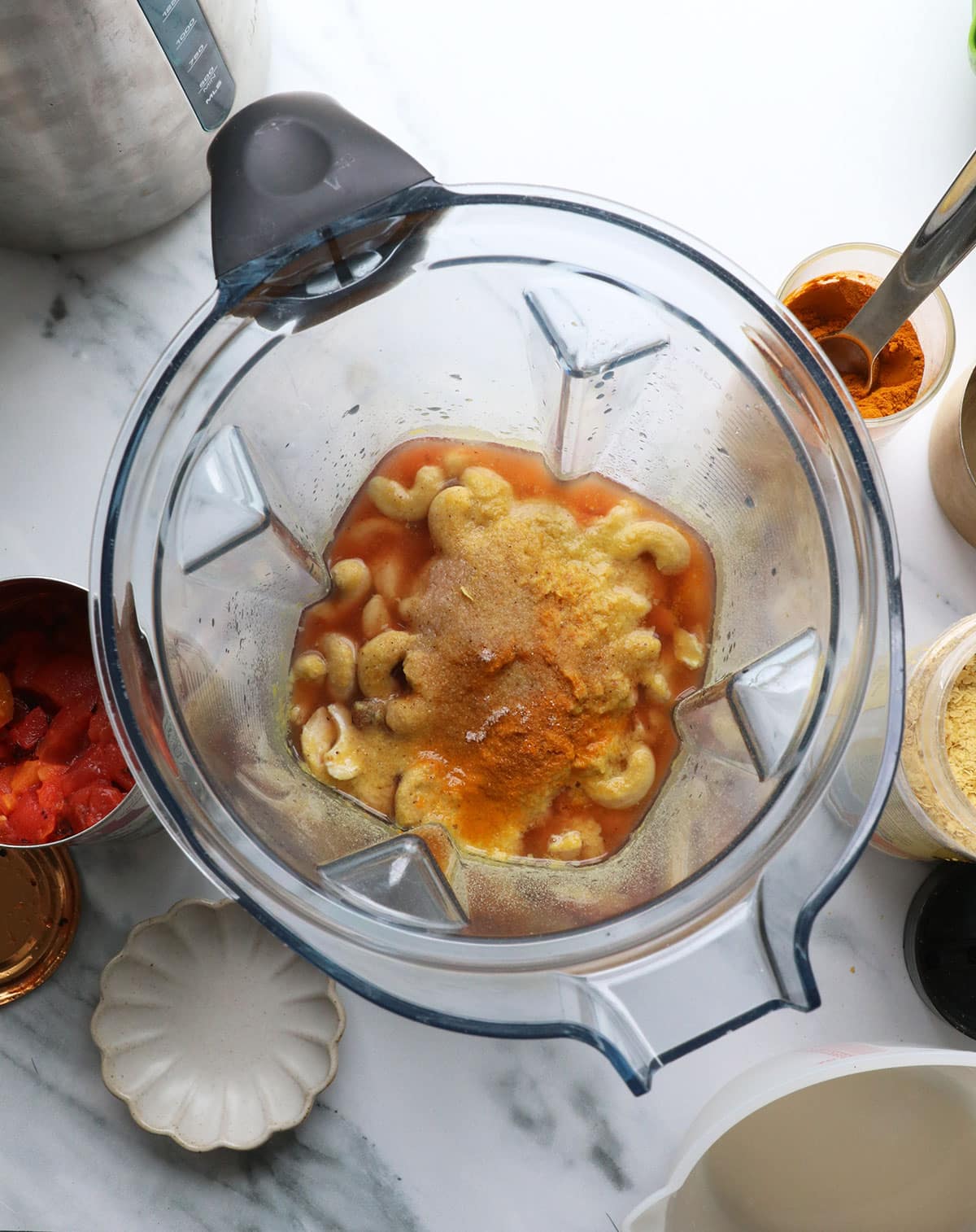 diced tomato juice and nutritional yeast in a blender with soaked cashews.