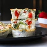 egg white bites stacked on dark plate to show texture.