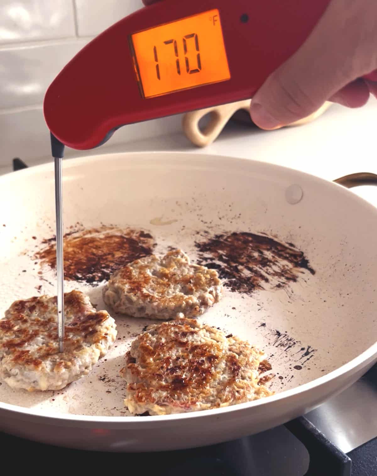 thermometer stuck in a sausage to check the internal temperature.