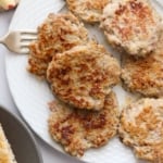 plate full of chicken apple sausage patties with a fork for serving them.