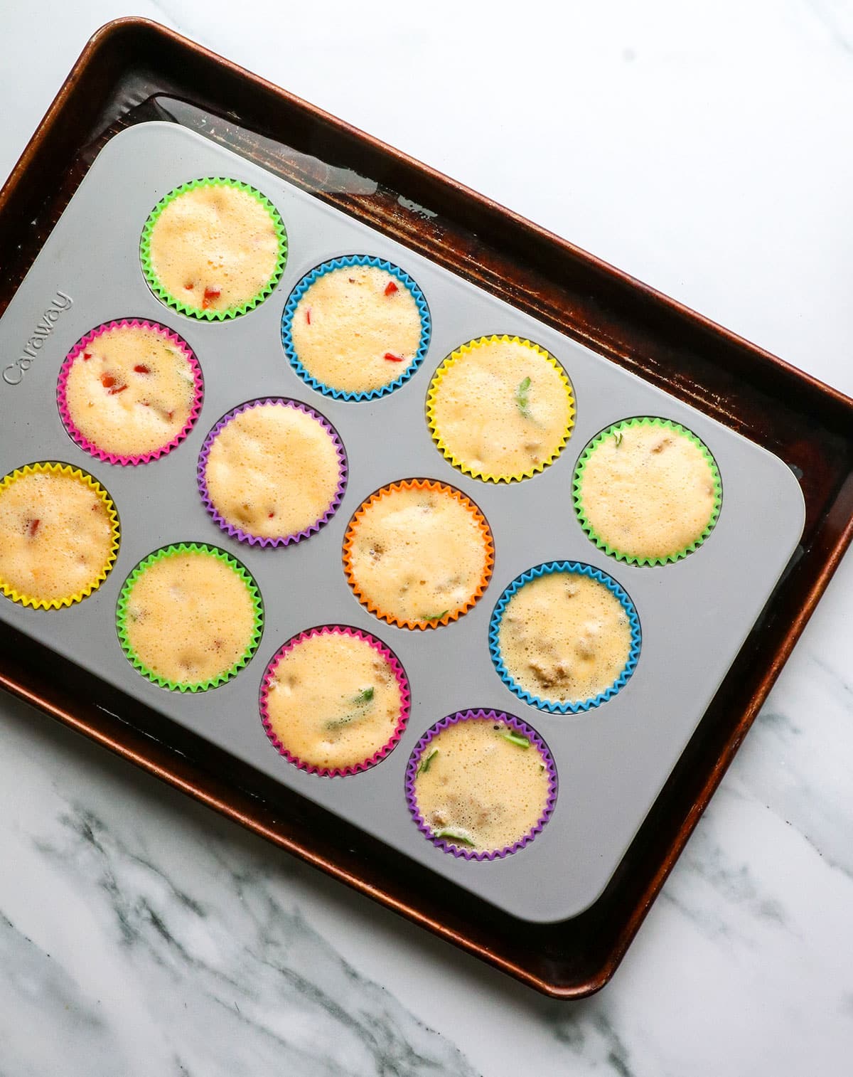 muffin pan with egg bites sitting in a pan of water.
