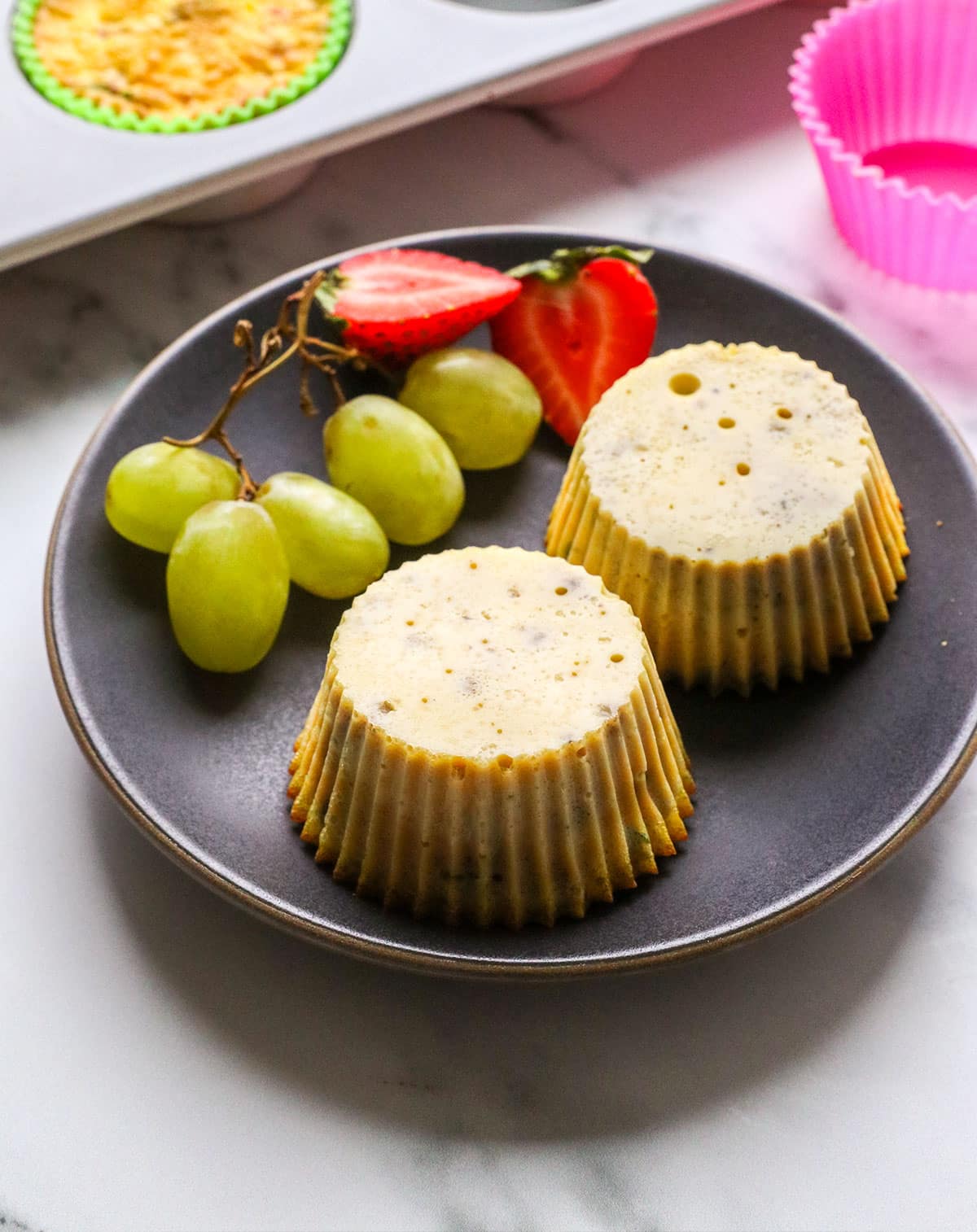 dairy-free egg muffins set on a dark plate.
