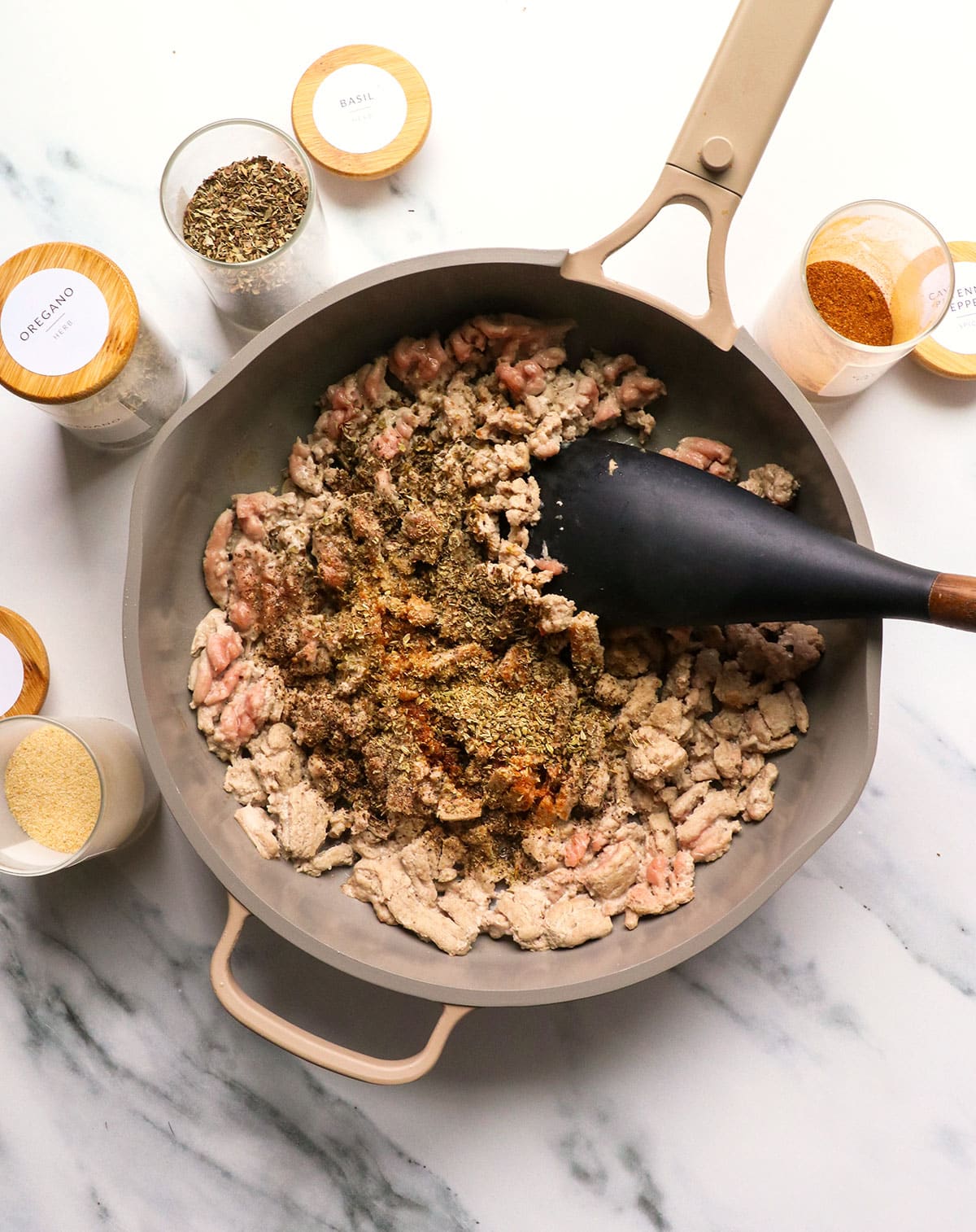 dried spices added to almost cooked turkey in a skillet.