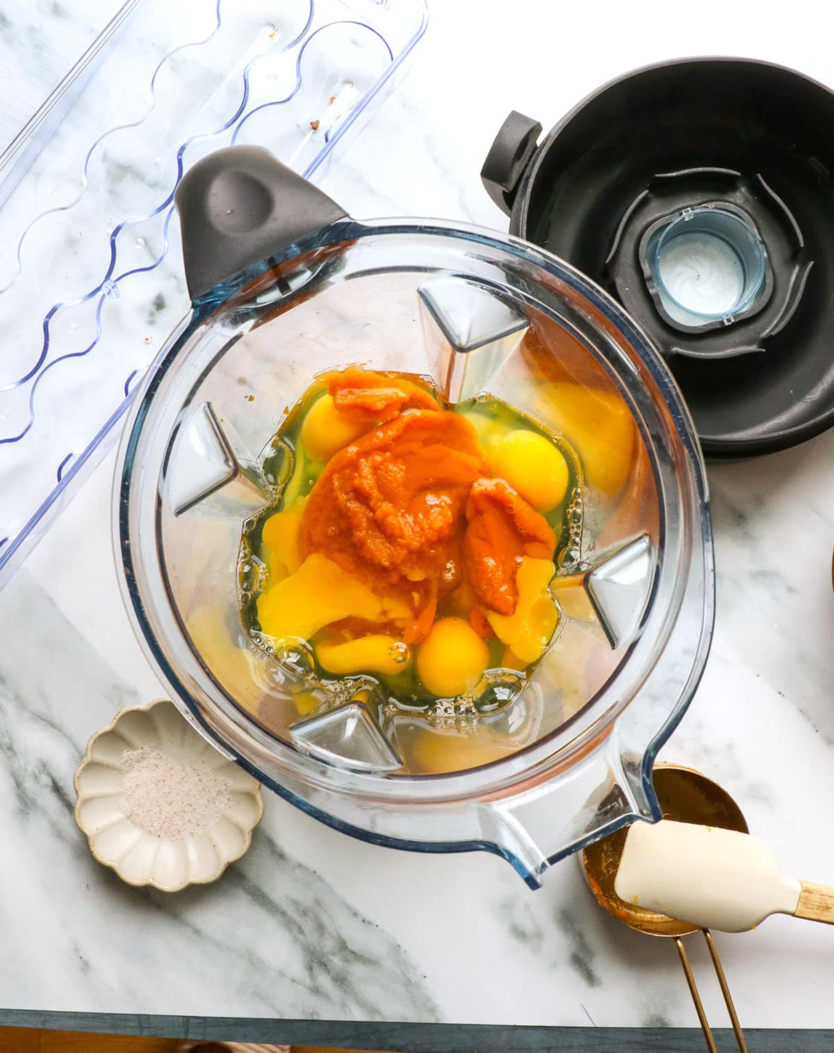 pumpkin and eggs added to a blender.