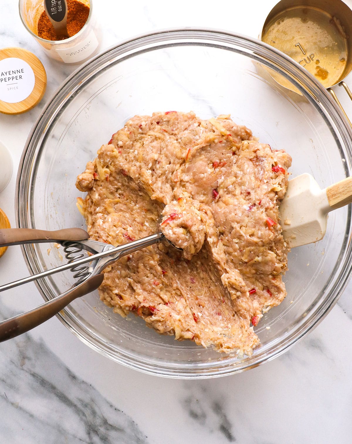 ground chicken and apple mixture scooped with a cookie scoop in the bowl.